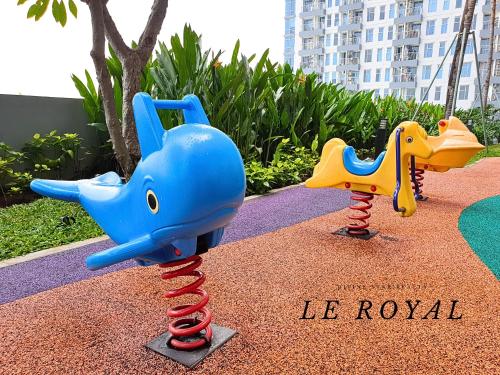 two childrens play equipment in a playground at Le Royal Benson Apartment at Supermal Pakuwon in Surabaya