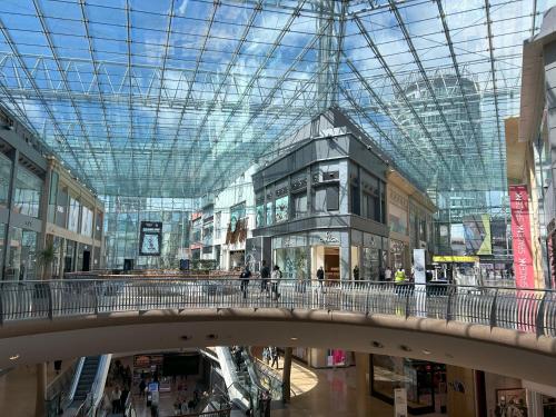 a shopping mall with a glass ceiling and a bridge at Birmingham City Centre, 2-Bedroom Apartment, 5 min walk from New Street Train Station in Birmingham