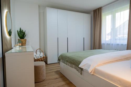 a bedroom with a bed and a large window at Apartment under the Larch in Jesenice