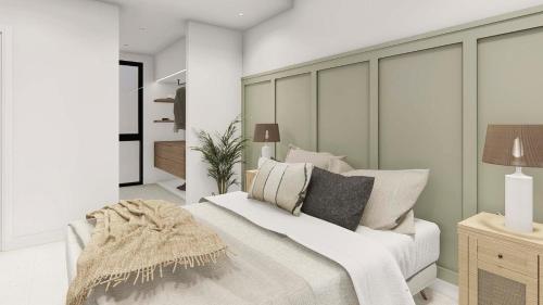 a bedroom with a white bed with pillows at Luxe zuiderse villa in Dolores