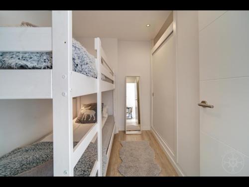 a bedroom with two bunk beds and a walk in shower at Tuc dera Llança en Baqueira in Naut Aran