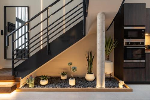 a staircase with potted plants in a room at Host Inn Wow House in Lyon