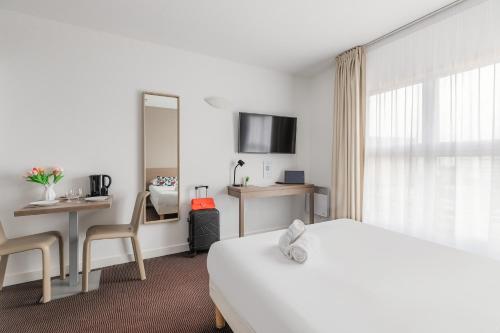 a hotel room with a bed and a table and chairs at Appart'City Classic Lyon Part Dieu Villette in Lyon