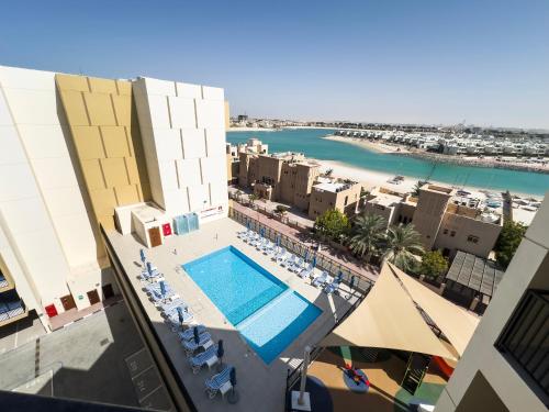 an aerial view of a resort with a swimming pool at Marina Residences Al Hamra Village in Ras al Khaimah