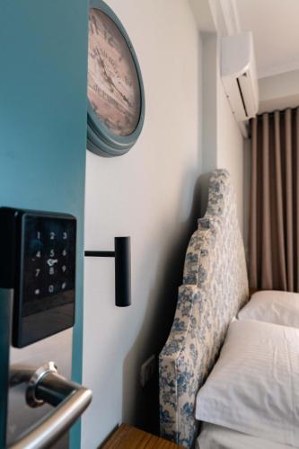 a room with a bed and a clock on the wall at Kristianna Apartments in Dhërmi