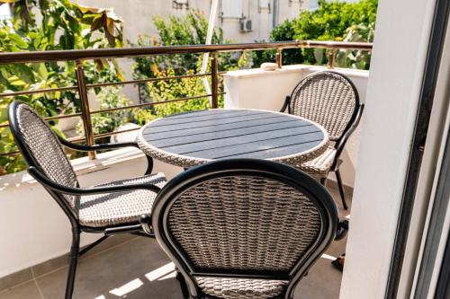 a table and chairs sitting on a balcony at Kristianna Apartments in Dhërmi