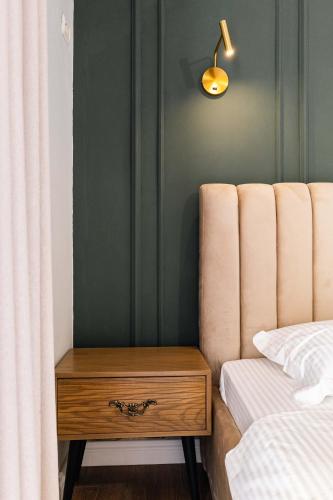 a bedroom with a bed and a nightstand next to a bed at Kristianna Apartments in Dhërmi
