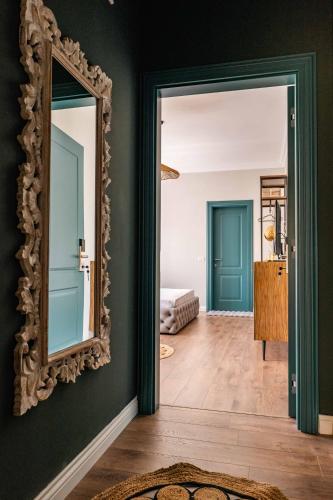 a hallway with a mirror and a bedroom at Kristianna Apartments in Dhërmi