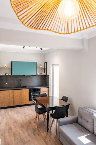 a living room with a table and a couch at Kristianna Apartments in Dhërmi