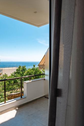 a balcony with a view of the ocean at Kristianna Apartments in Dhërmi