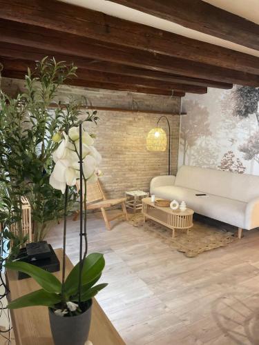 a living room with a couch and a table at Le Clos du Léman I Charme & Sauna in Anthy