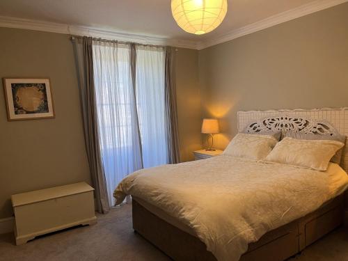 a bedroom with a bed and a large window at Humphreston House in Bristol