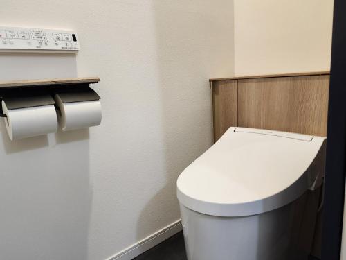a bathroom with a white toilet in a room at Pension Green Lake in Gujo