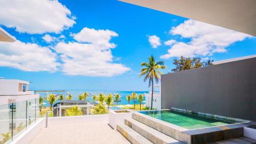 a view of the ocean from the balcony of a house at Latitude By Horizon Holidays in Rivière Noire