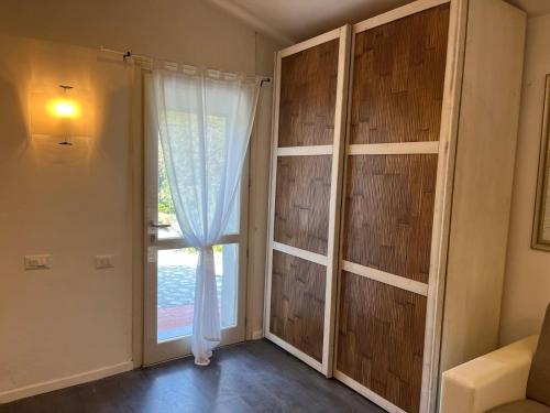 a room with a large window and a curtain at Casa Bianca in Vaiano