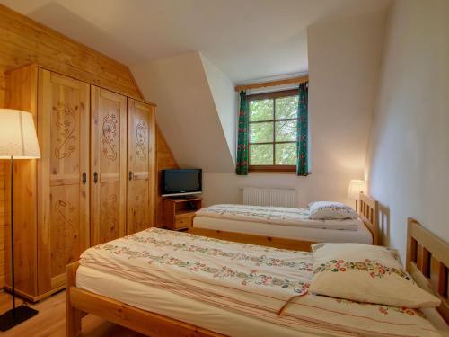 a bedroom with two beds and a television at Apartament Krupówki 73 - 2-7 person in Zakopane