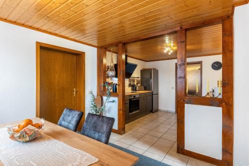 a kitchen and dining room with a wooden table and chairs at Ferienwohnung Boddenberg in Waldbröl