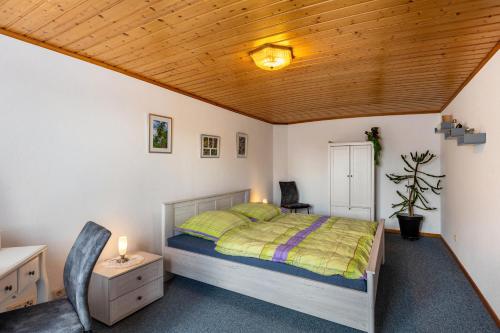 a bedroom with a bed and a wooden ceiling at Ferienwohnung Boddenberg in Waldbröl