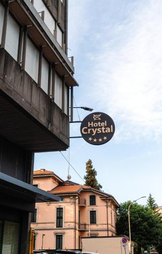 a sign on the side of a building next to a building at Crystal Hotel Varese in Varese