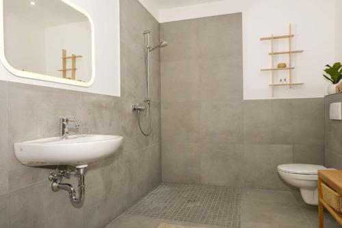 a bathroom with a sink and a toilet and a mirror at Achterdeck in Eckernförde