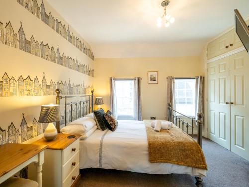 una camera da letto con un letto e una scrivania di Pass the Keys Bright and cosy flat in the centre of Much Wenlock a Much Wenlock