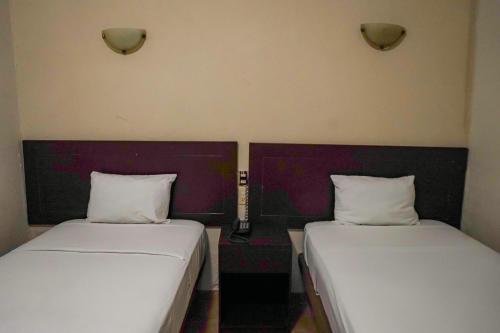 Ένα ή περισσότερα κρεβάτια σε δωμάτιο στο OYO Hotel Plaza Veracruz Centro Historico