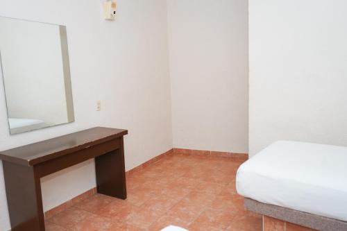 Ένα ή περισσότερα κρεβάτια σε δωμάτιο στο OYO Hotel Plaza Veracruz Centro Historico
