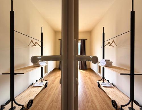 a dressing room with wooden floors and mirrors at Oishe View in Stepantsminda