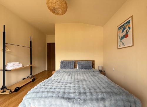 a bedroom with a large bed with blue pillows at Oishe View in Stepantsminda