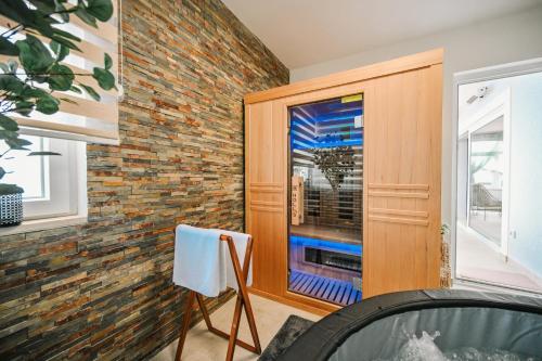 a room with a brick wall and a window at Petra Hills Majestic in Opatija