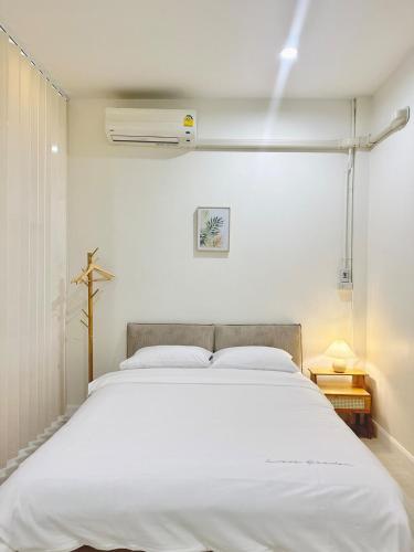 a bedroom with a large white bed in it at Midori Haus-7mins to LeeGarden in Hat Yai