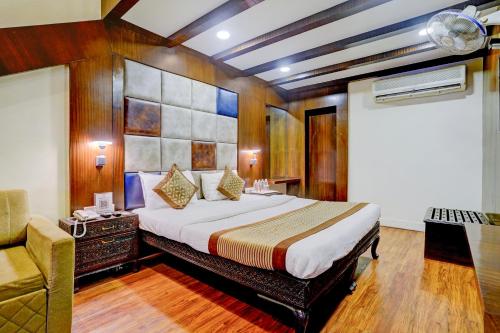 a bedroom with a bed and a chair in it at The Byke Heritage Resort - Matheran in Matheran