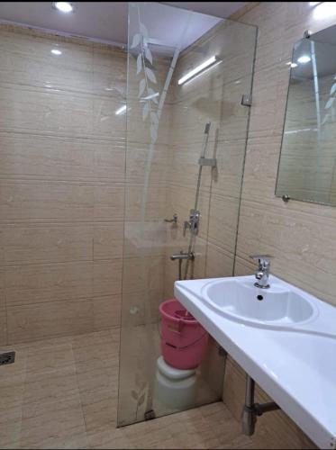 a bathroom with a sink and a shower with a toilet at The Byke Heritage Resort - Matheran in Matheran