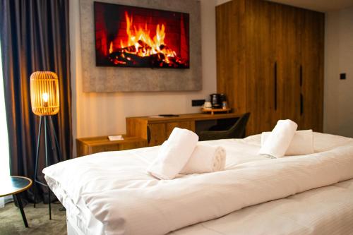a hotel room with a bed with a fireplace at Penzión Furkotka in Štrbské Pleso
