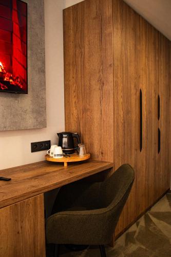 a room with a wooden desk with a telephone on it at Penzión Furkotka in Štrbské Pleso