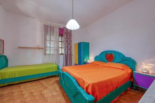 a bedroom with two beds with colorful sheets at Sprocketlandia in Frigole