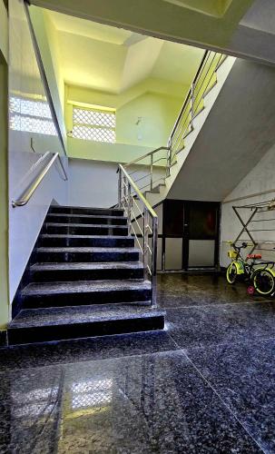 an empty room with stairs in a building at Kasa homestay in Dibrugarh