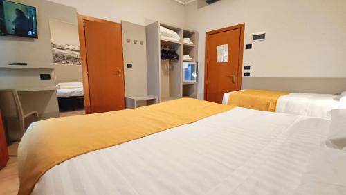 a hotel room with two beds and a television at Valmarina in Calenzano