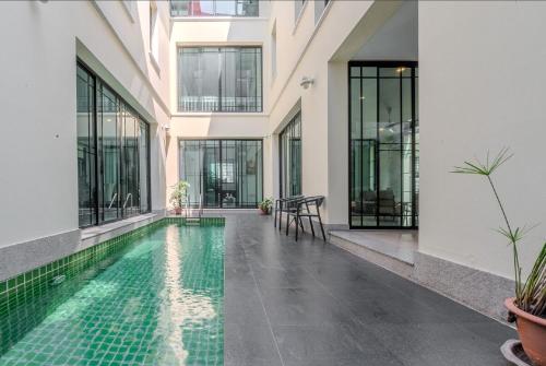 a swimming pool in the middle of a building at Sukumvit Pool Villa 5BR 5-7min-walk to Thonglor Sky train in Klong Toi