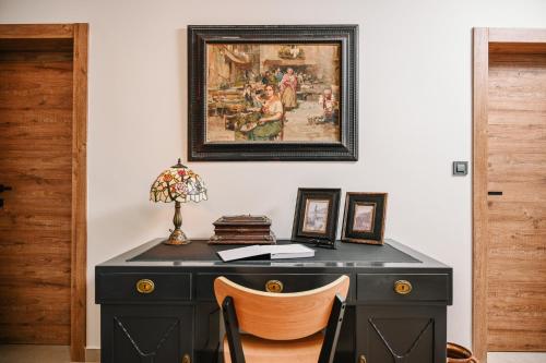 a black desk with a picture on the wall at Petra Hills Majestic in Opatija
