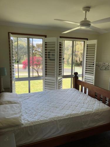 a bedroom with a bed and a large window at Walpole House in Walpole