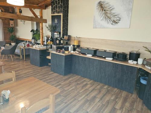 a restaurant with a counter with tables and chairs at Hotel Taurus in Ostrava