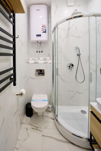 a white bathroom with a shower and a toilet at Forest Retreat Center in Kyiv