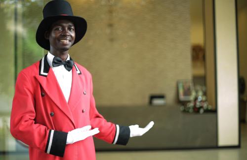 a man in a red suit and top hat at GHS Hotel in Brazzaville
