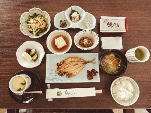 a table with various dishes of food and drinks at Shin Kadoya in Atami