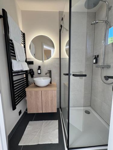 a bathroom with a glass shower and a sink at Luxuscontainer am Nürburgring #1 in Adenau