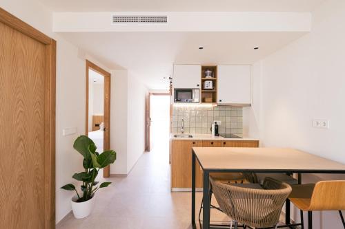 a kitchen and dining room with a table and chairs at Malacosta A - MC Apartments Ibiza in Ibiza Town