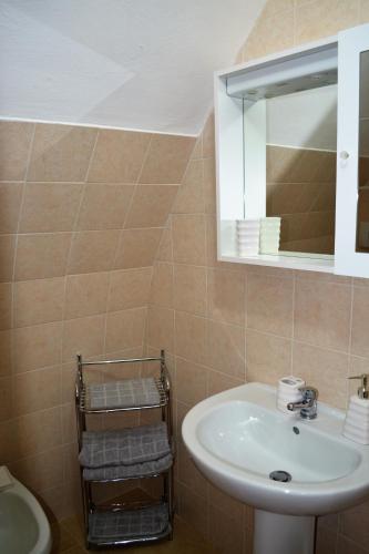 a bathroom with a sink and a mirror and a toilet at B&B S.Antonio in Bari