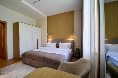 a hotel room with a bed and a chair at Forest Retreat Center in Kyiv