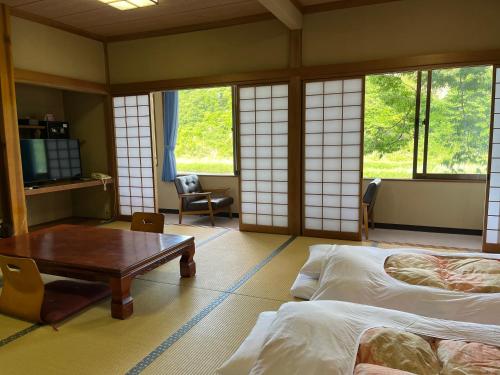Postel nebo postele na pokoji v ubytování 料理自慢の温泉宿せせらぎ荘